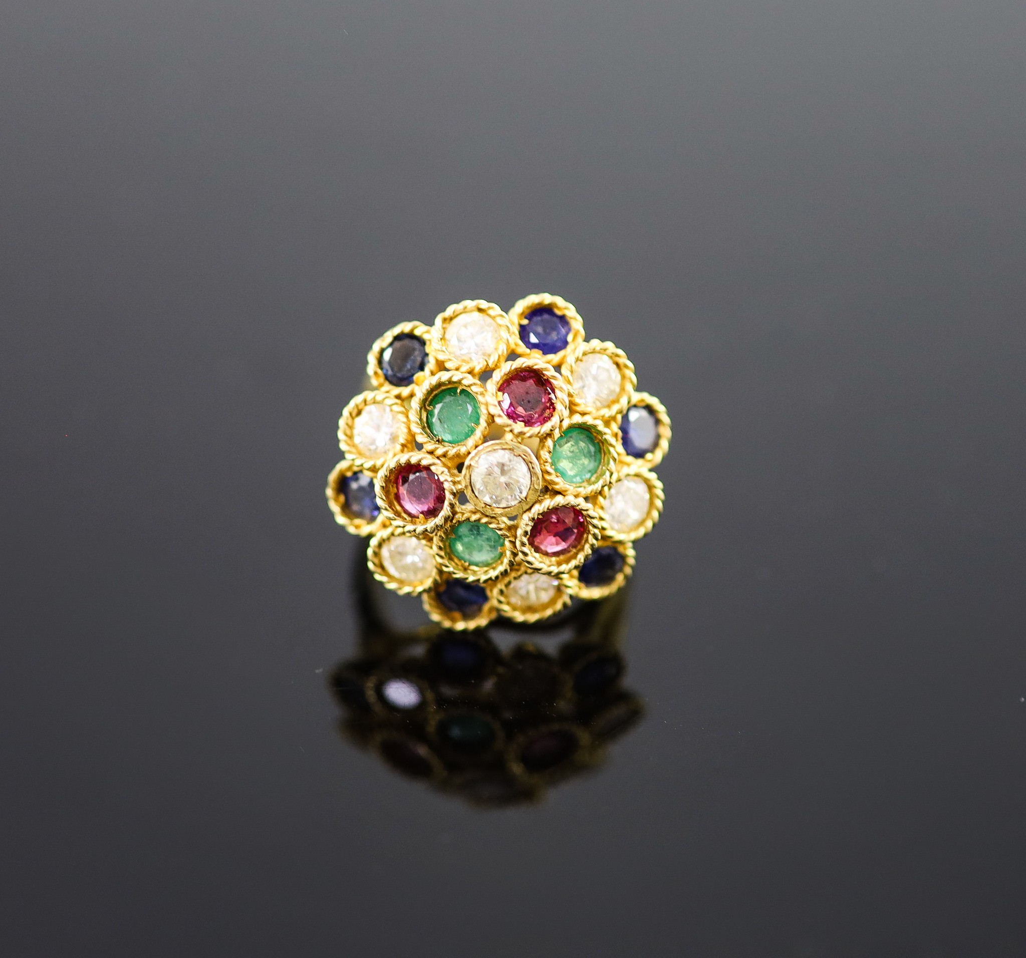 A continental gold (stamped 850) and multi gem set circular dress ring